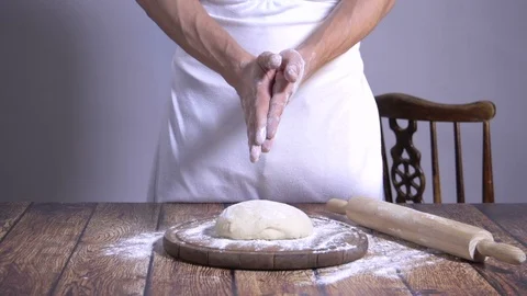 Chef. Baker. Sprinkle with flour dough. making pasta, pizza Video stock 90223057