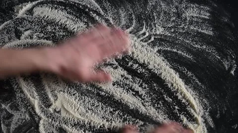 Chef baker sprinkles flour on the table Stock Footage 158871756