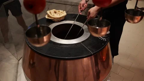 Chef baking naan bread in traditional tandoor oven Stock Footage 330262696