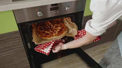The chef is baking a raw pepperoni pizza in the oven Stock Footage 280159847