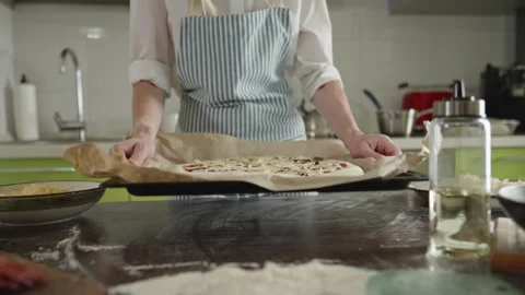 The chef is baking a raw pizza with mushrooms in the oven Stock Footage 280157955