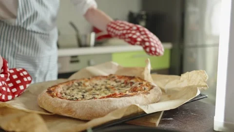The chef is baking a raw pizza with mushrooms in the oven Stock Footage 280158055