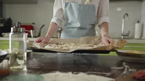 The chef is baking a raw pizza with mushrooms in the oven Stock Footage 280159233