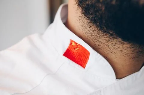 Chef with a beard wearing a work jacket with the Chinese flag Stock Photos