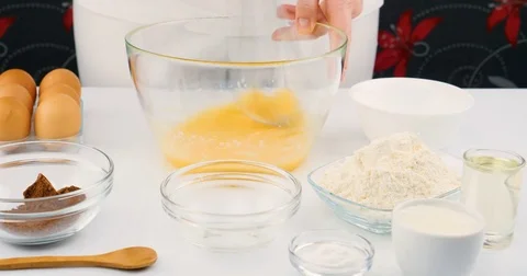 Chef beating eggs and milk in a bowl with hand mixer Stock Footage 75911967