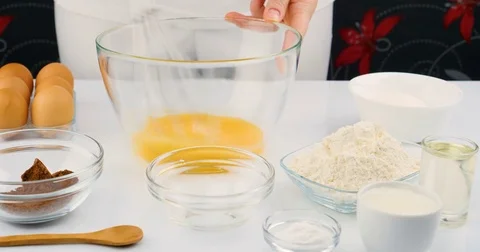 Chef beating eggs and sugar in bowl to make chocolate cake Stock Footage 75910917