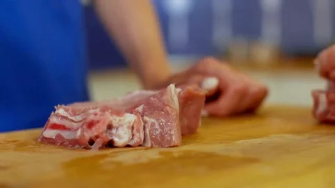 Chef beating meat with a hammer in the kitchen Stock-Footage 333834354