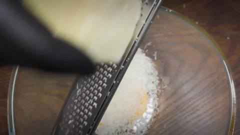 Chef beats egg yolks with Parmesan cheese Vidéo 301666363