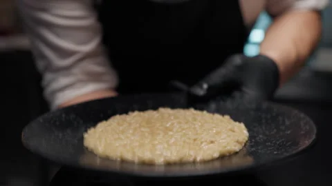 Chef beats risotto dish in the kitchen Stock Footage 248969918