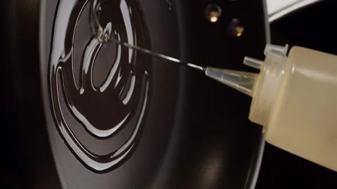 The chef beautifully and elegantly pours oil by thin trickle into a hot frying Video stock 168473919