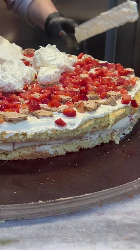 Chef in black gloves in cafe kitchen applies white creamy curd cream Stock-Footage 329666967