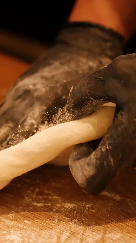 Chef in Black Gloves Kneading Pizza Dough on Wooden Table Stock Footage 338424893