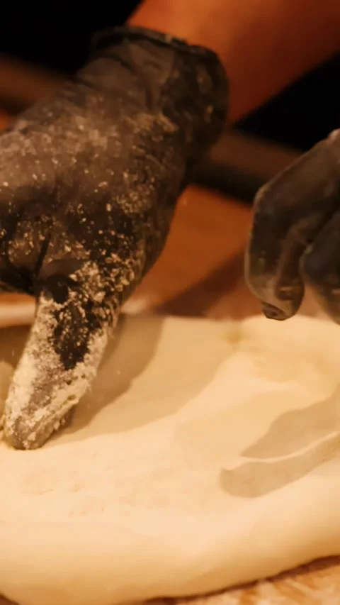 Chef in Black Gloves Kneading Pizza Dough on Wooden Table Stock Footage 339514845