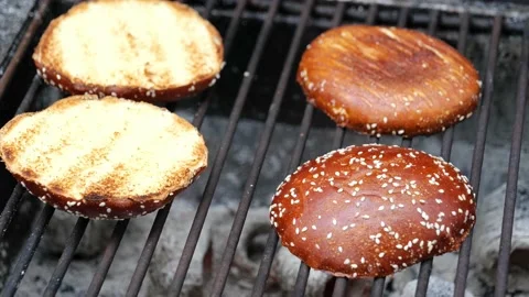 Chef in black gloves making and grilling burger buns outdoor Stock Footage 206809467
