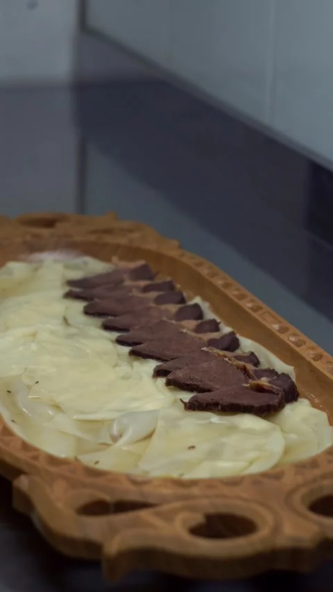 Chef in black gloves placing sliced boiled beef and kazi horsemeat sausage over  Stock Footage 341352363