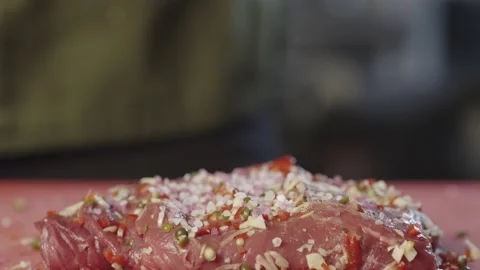 The chef in black gloves pours coarse salt on the steak. Stock Footage 233812910
