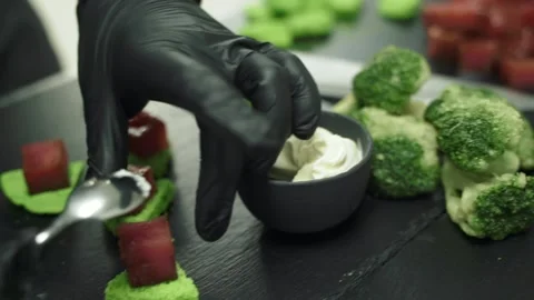 Chef in black gloves prepares delicious snacks, close-up Stock Footage 172019037