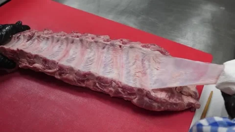 Chef in Black Gloves Prepping Raw Pork Baby Back Ribs for Barbecue Stock Footage 338212219