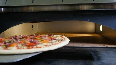 The chef in black gloves puts the pizza in the oven and closes the door slow Видео 230076070