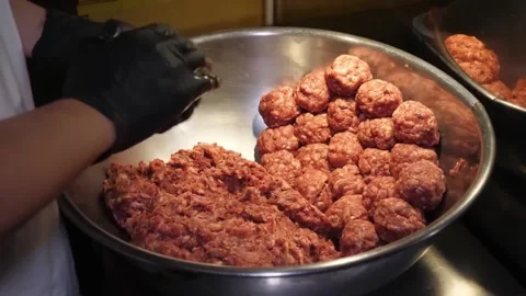 Chef in Black Gloves Rolling Raw Meatballs in Metal Bowl Stock-Footage 347689202