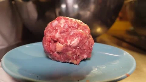Chef with Black Gloves Shaping Raw Meat Patty on Blue Plate Stock-Footage 347689192