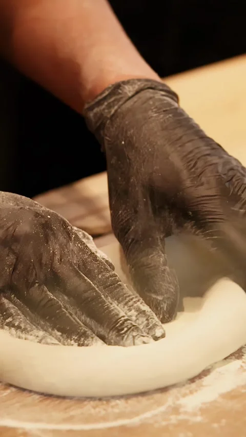 Chef in Black Gloves Stretching Pizza Dough in Restaurant Kitchen Stock Footage 344514464