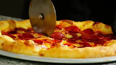 Chef in black rubber gloves cuts pizza on plate using sharp knife Stock Footage 326370506