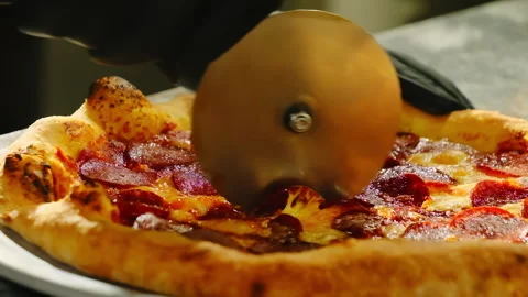 Chef in black rubber gloves cuts pizza using special sharp knife Stock Footage 326371033