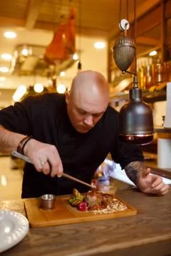 Chef in a black uniform jacket Stock Photos