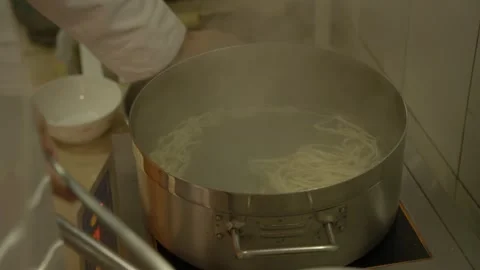 Chef Boiling and Preparing Noodles in a Steaming Pot in Beijing Kitchen Stock Footage 345891041