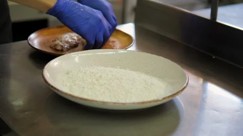 Chef is breading meat in flour closeup Stock Footage 119547005