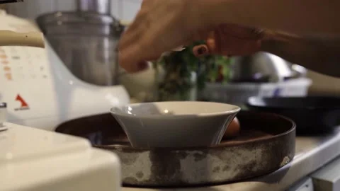 Chef is breaking eggs to make an omelette Stock Footage 180980373