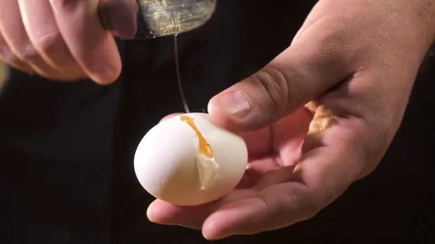 The chef breaks the egg and shows the contents Stock Footage 76397426
