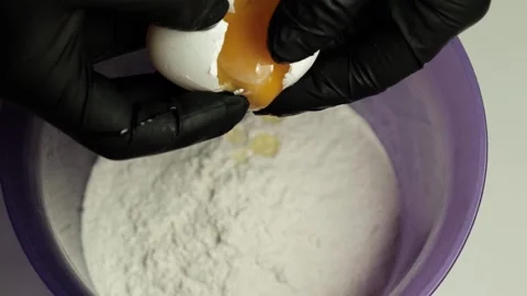 The chef breaks the egg into flour to knead the dough. Stock Footage 201145313