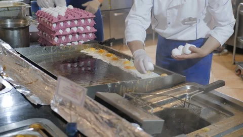 Chef breaks egg into frying pan. Process... | Stock Video | Pond5