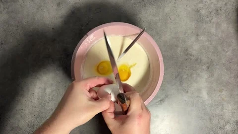 Chef breaks egg with knife on kitchen table Stock Footage 304767365
