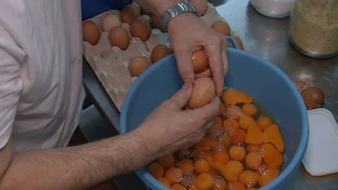 Chef breaks eggs for making the dough, pies bread and bakery, cooking with eggs, Stock Footage 90223265