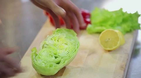 Chef breaks fresh crispy iceberg salad slowmotion Stock Footage 58407766