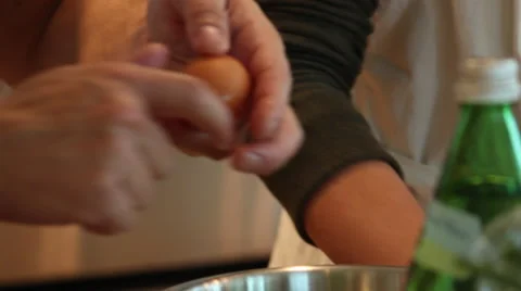 Chef Breaks Two Eggs into Bowl Video stock 61408800