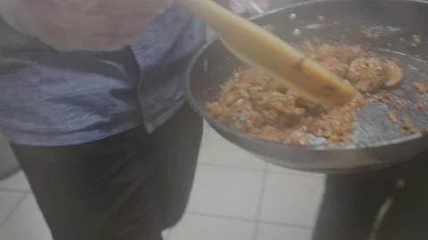 Chef brings just cooked chashushuli and puts dish into an iron plate. Georgian Stock Footage 134208553
