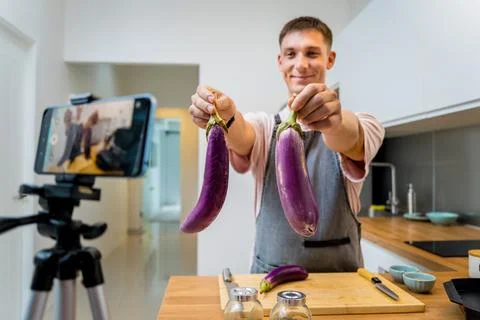 The chef is broadcasting live from workshop how to prepare a grilled eggplants Stock Photos