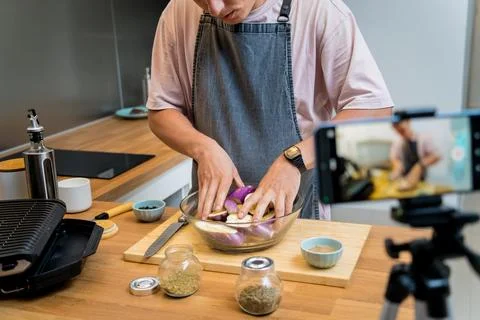 The chef is broadcasting live from workshop how to prepare a grilled eggplants Stock Photos