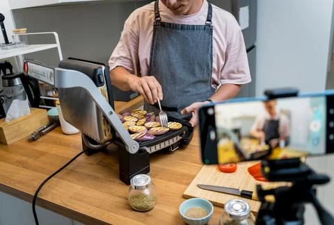 The chef is broadcasting live from workshop how to prepare a grilled eggplants Stock Photos