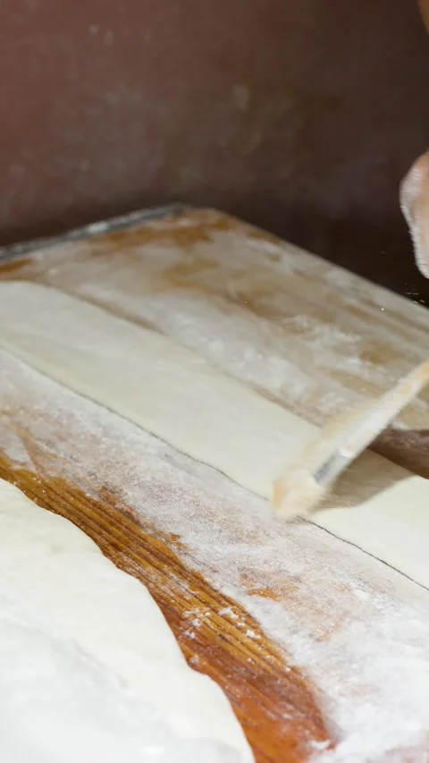 Chef Brushing Flour and Folding Dough on Wooden Table Stock Footage 340244056