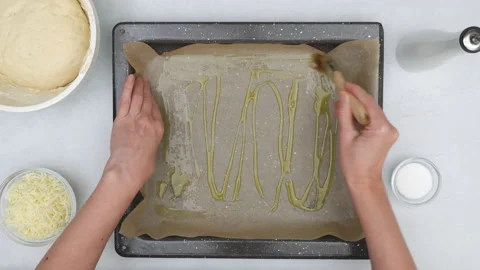  Chef brushing parchment paper with olive oil, close up baking process, flat lay Stock Footage 145785879