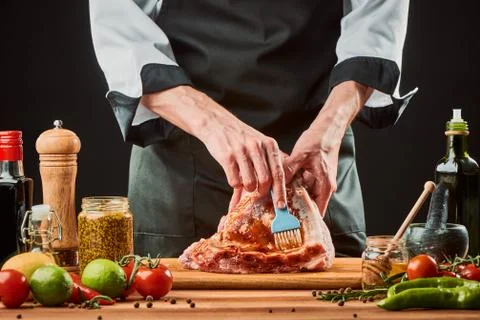 Chef brushing raw beef ribs with marinade Stock Photos