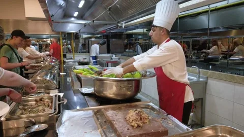 A chef in a buffet restaurant cuts a lamb stew. Buffet restaurant in the reso Stock Footage 198238588