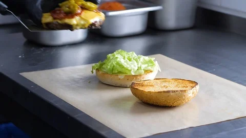 Chef builds burger. Preparing of the burger Stock Footage 86429425