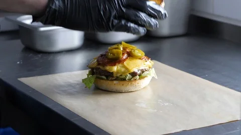 Chef builds burger. Preparing of the burger Stock Footage 86429766