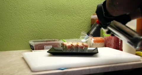 Chef burning delicious sushi from a torch Stock Footage 285436060